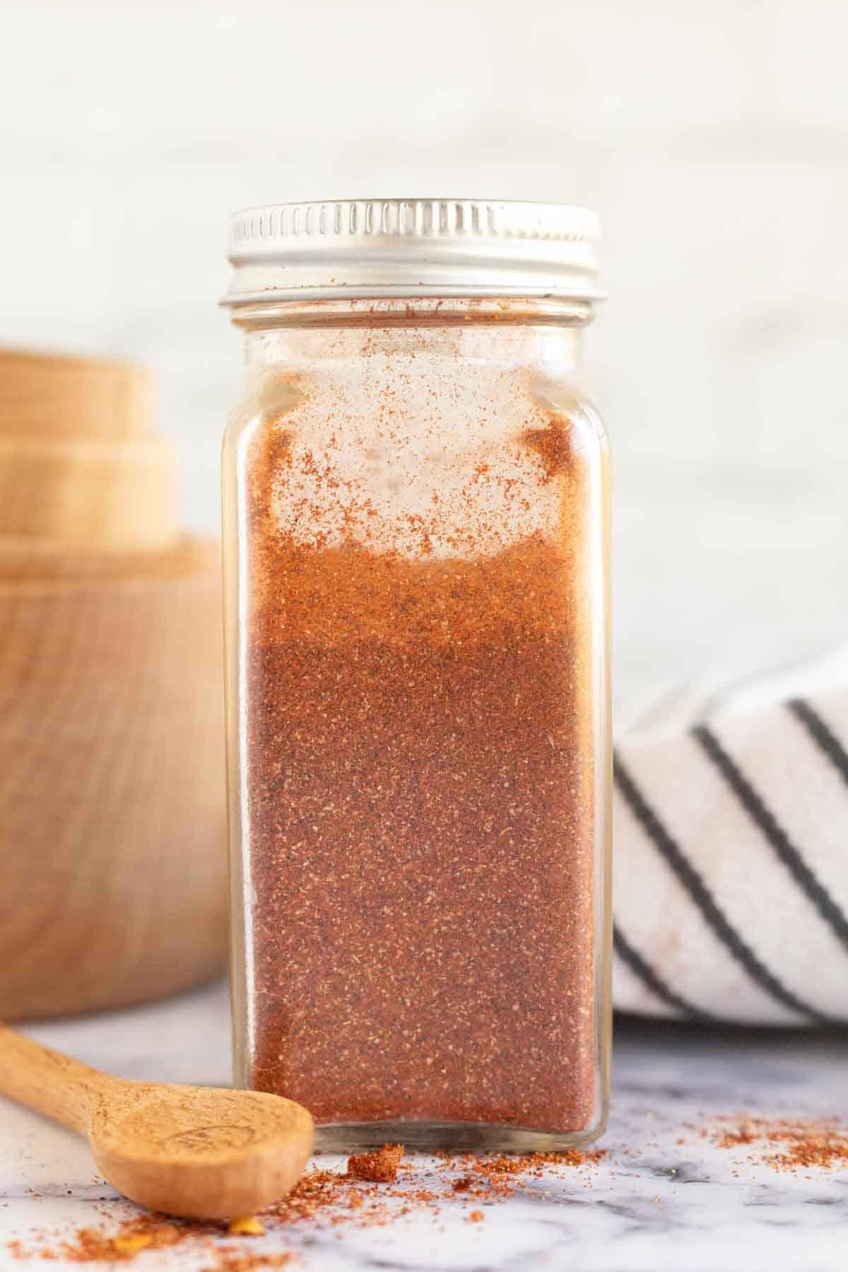 Καρύκευμα Αντόμπο 3 a glass container with a silver lid with homemade adobo seasoning