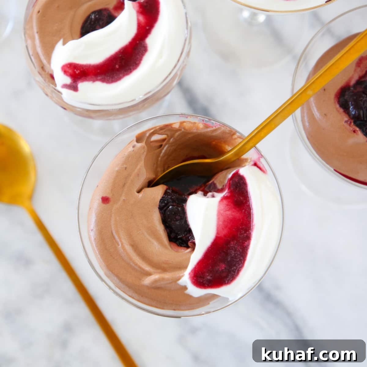 Decadent chocolate mousse in an elegant glass with a gold spoon, ready to be enjoyed.