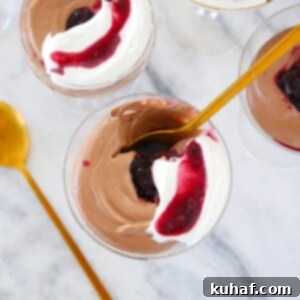 Chocolate Mousse in glass with gold spoon.