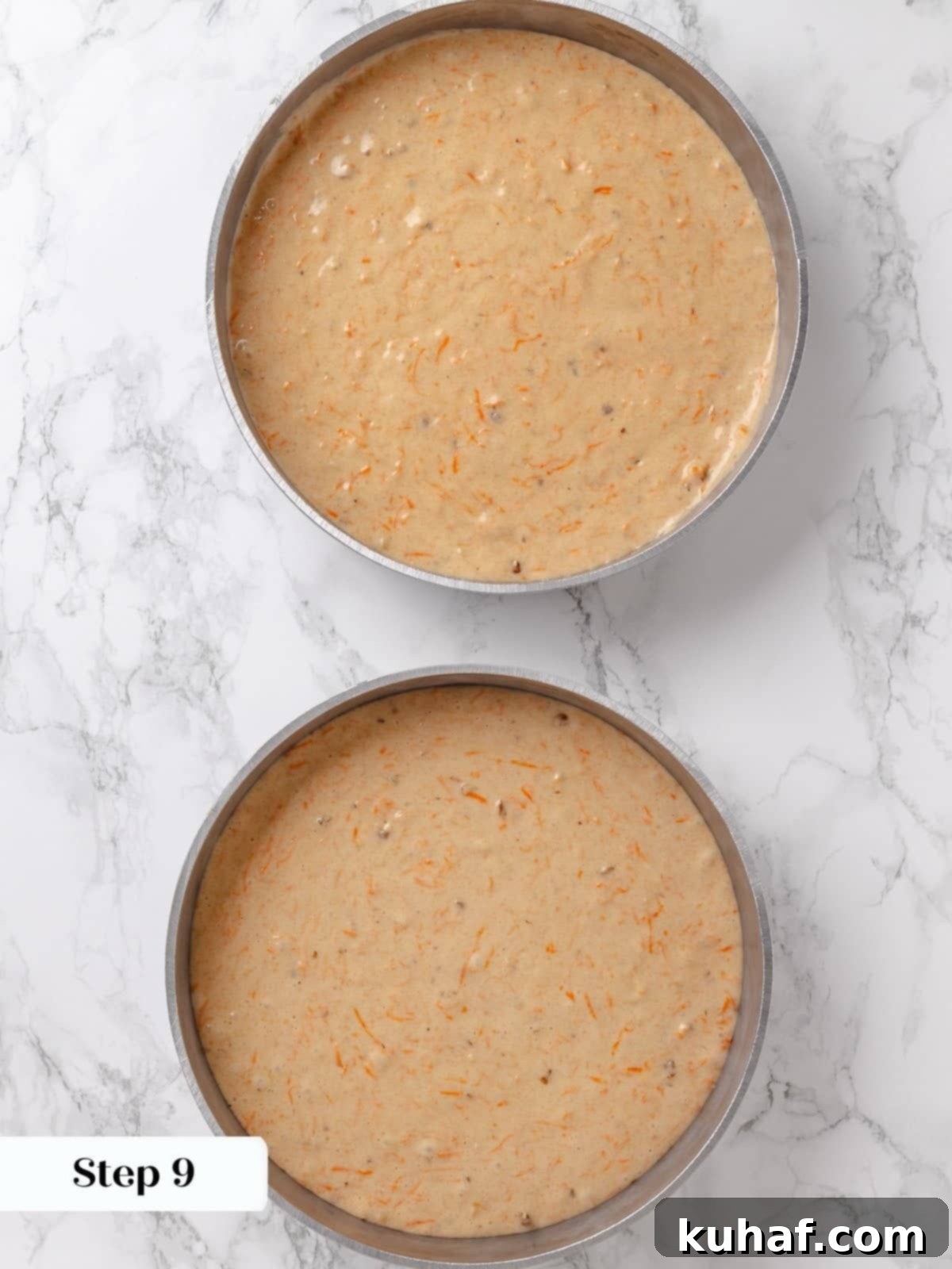 Dividing cake batter evenly into two round cake pans.