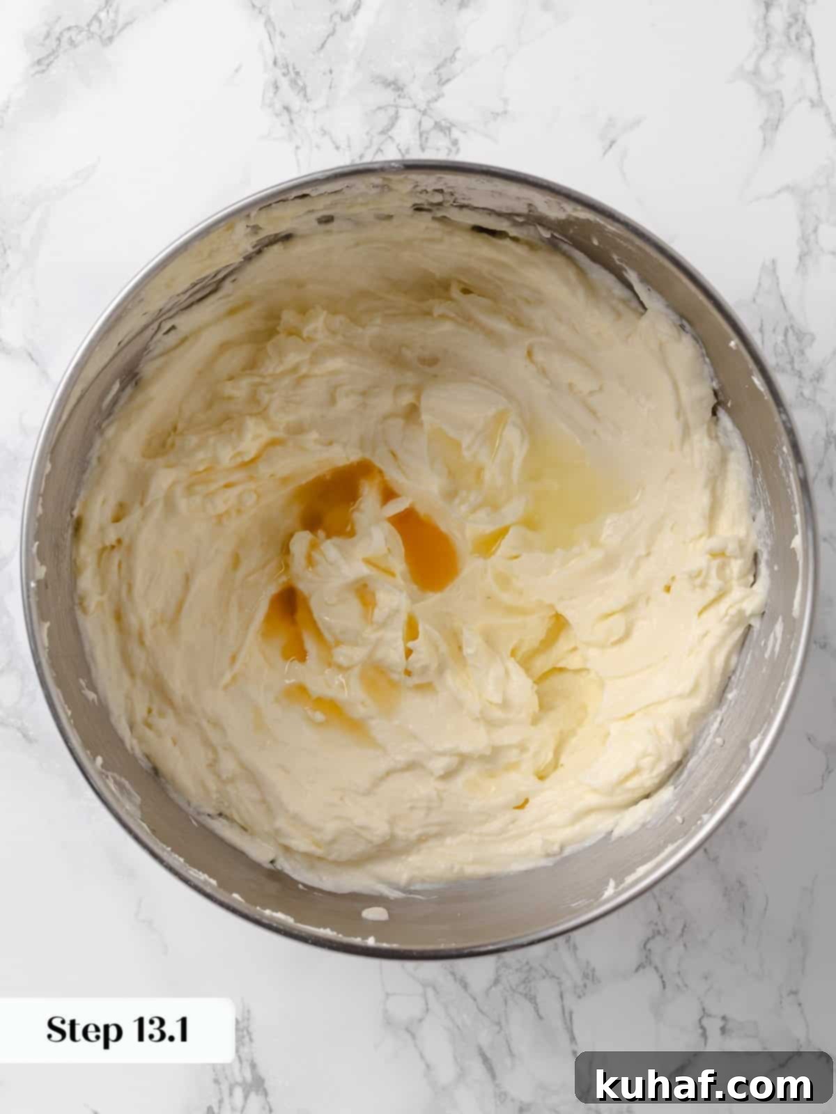 Vanilla extract poured into the cream cheese frosting mixture.