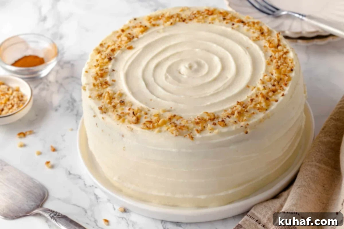 Frosted carrot cake with a smooth, clean swirl top, ready for serving.