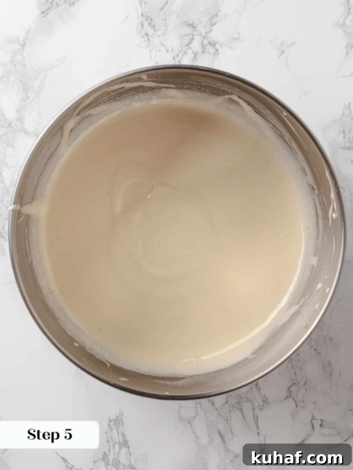 Egg and sugar mixture, pale and voluminous, demonstrating the ribbon stage.