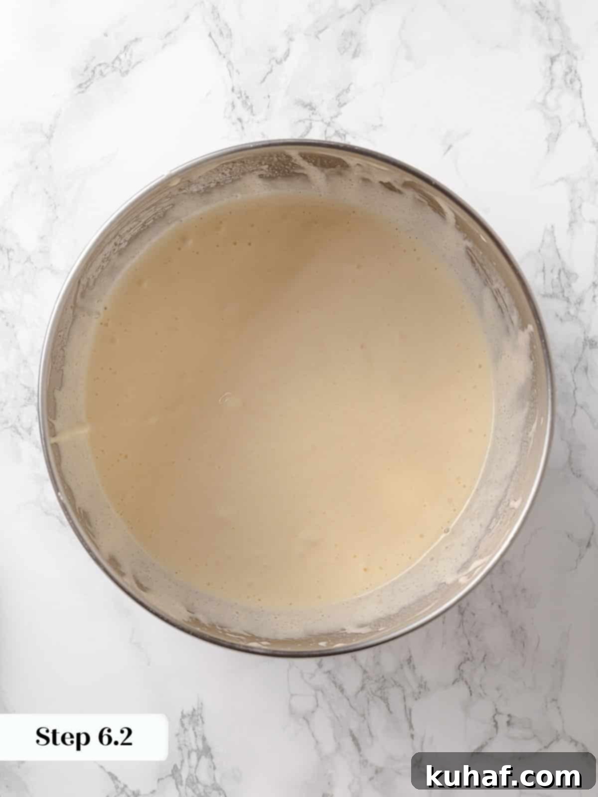 Vegetable oil and lemon juice mixture added to a bowl of fluffy eggs and sugar.