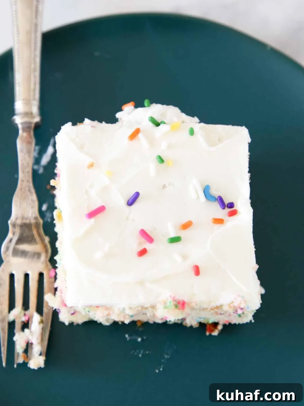 Smooth lemon buttercream frosting spread evenly on a sheet cake.