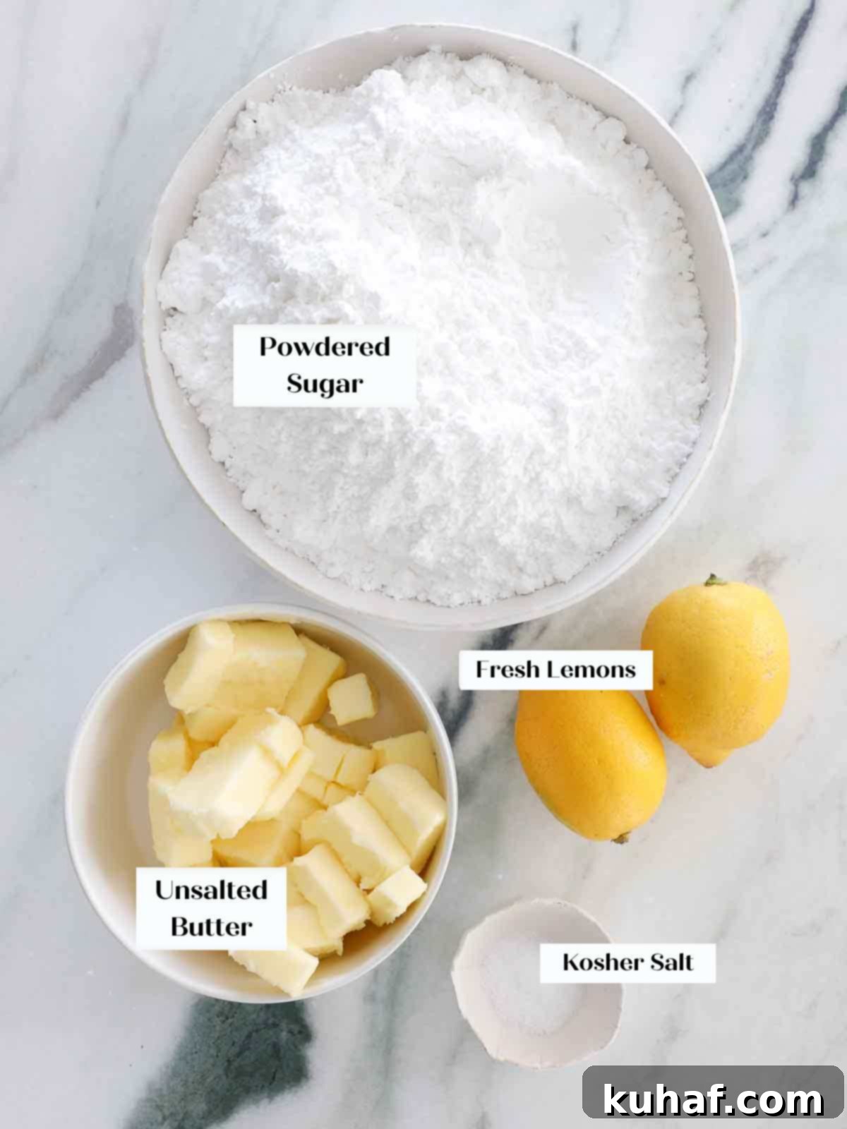Ingredients for creamy lemon buttercream frosting, including powdered sugar, butter, and fresh lemons.