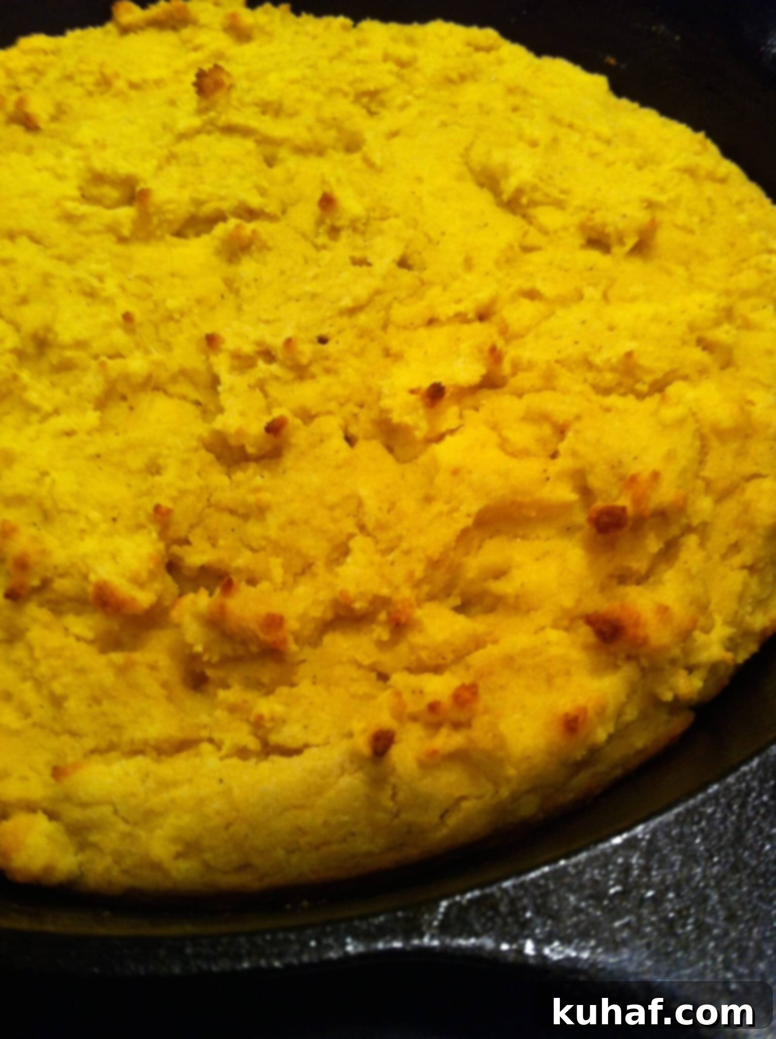 Northern Johnny Cake baking in a cast iron skillet