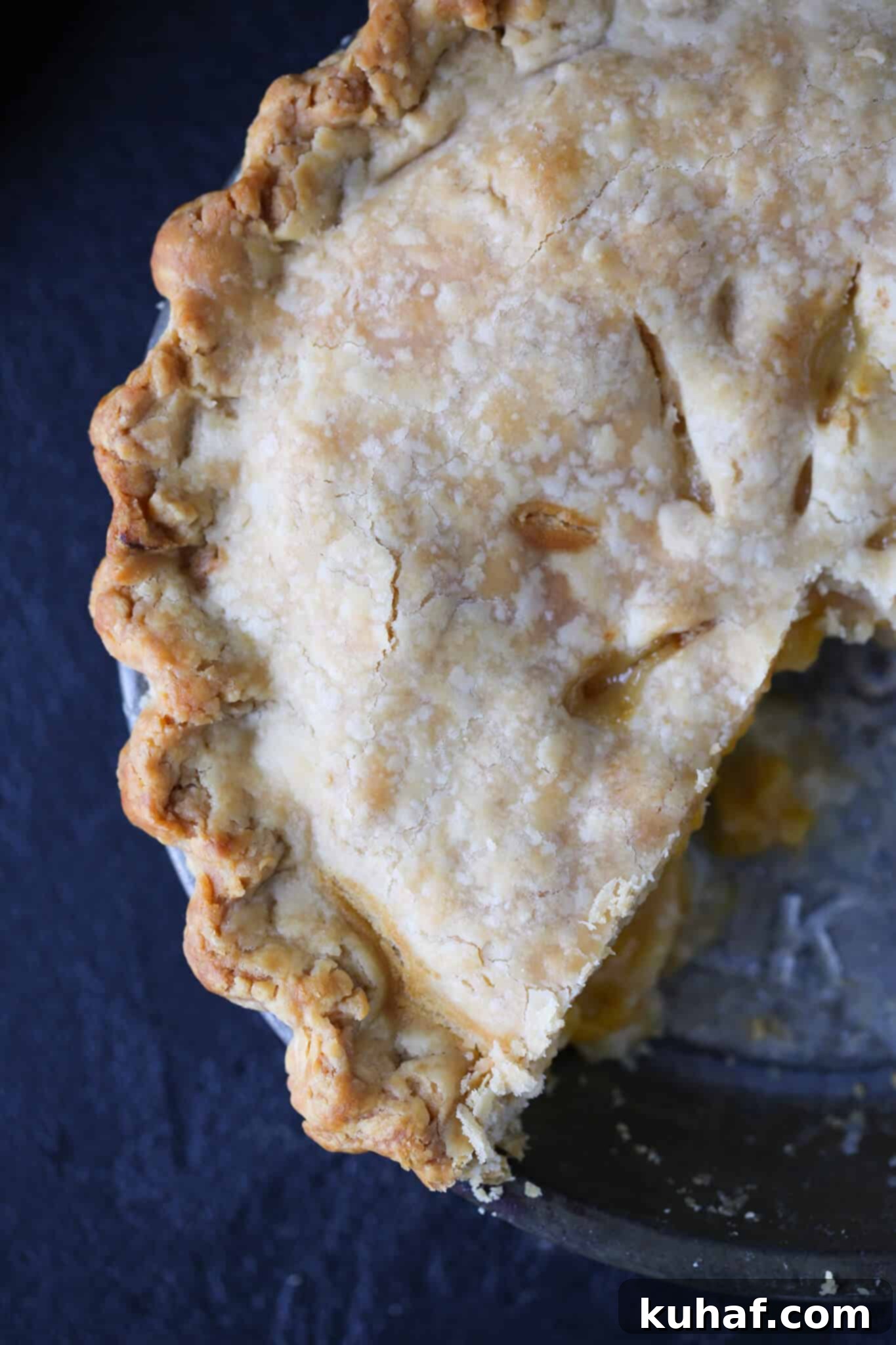 Old Fashioned Peach Pie sliced in vintage pie tin.