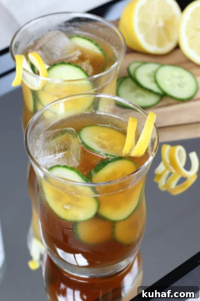Cucumber Pimms Cooler 4 A close-up of the Pimm's Cup ingredients: Pimm's No. 1 bottle, fresh lemons, and crisp cucumbers.