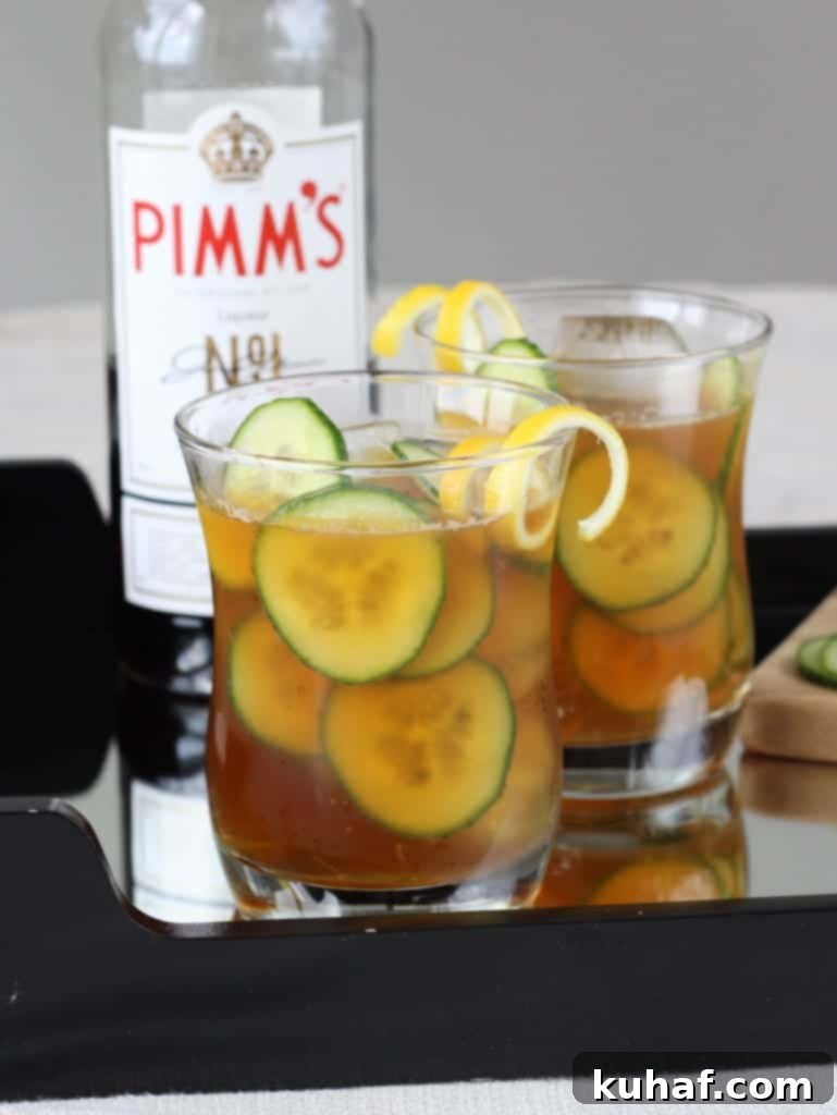 Cucumber Pimms Cooler 6 Two glasses of Cucumber Pimm's Cup, perfectly garnished and ready to be served on a bright day.