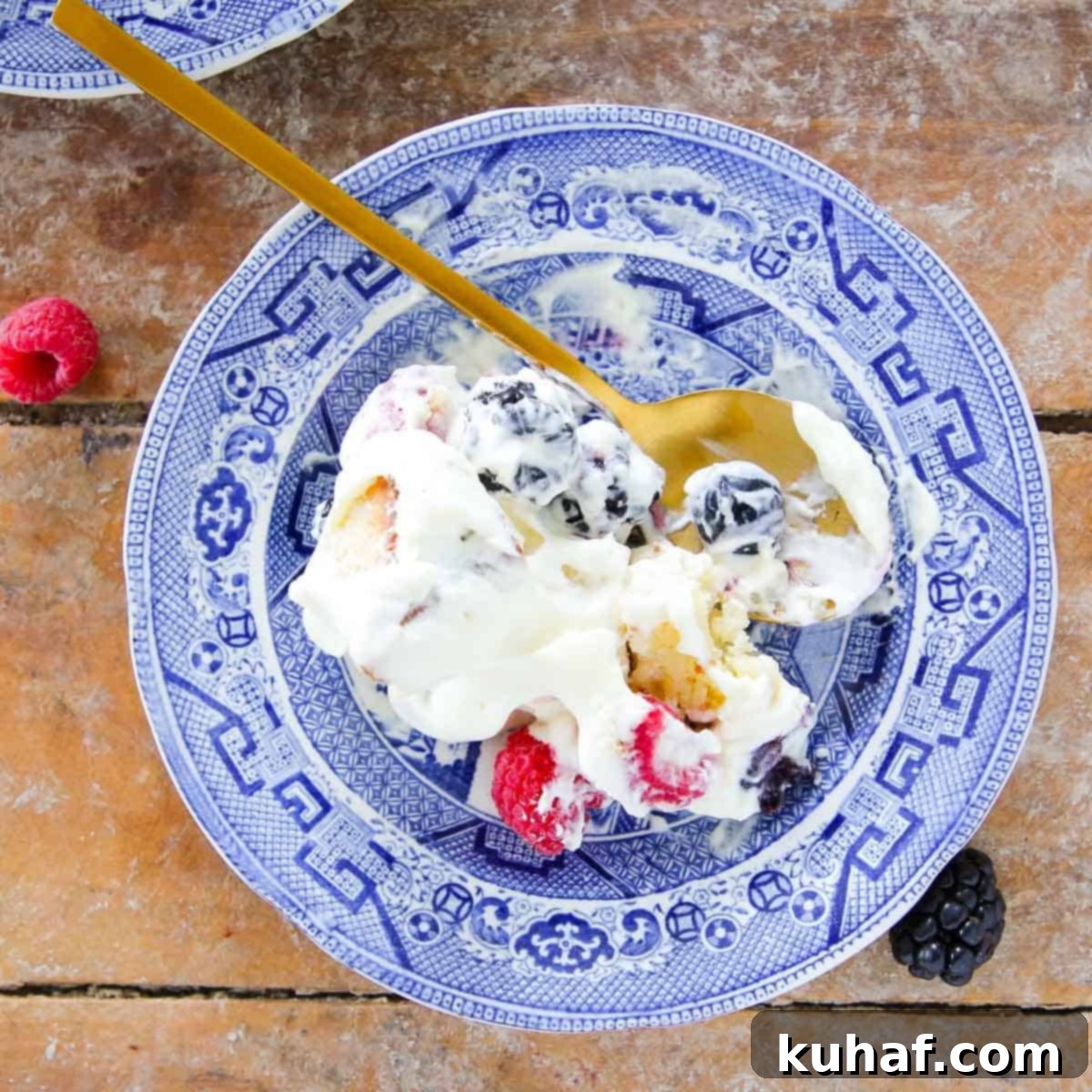 served berry trifle on blue vintage plate.