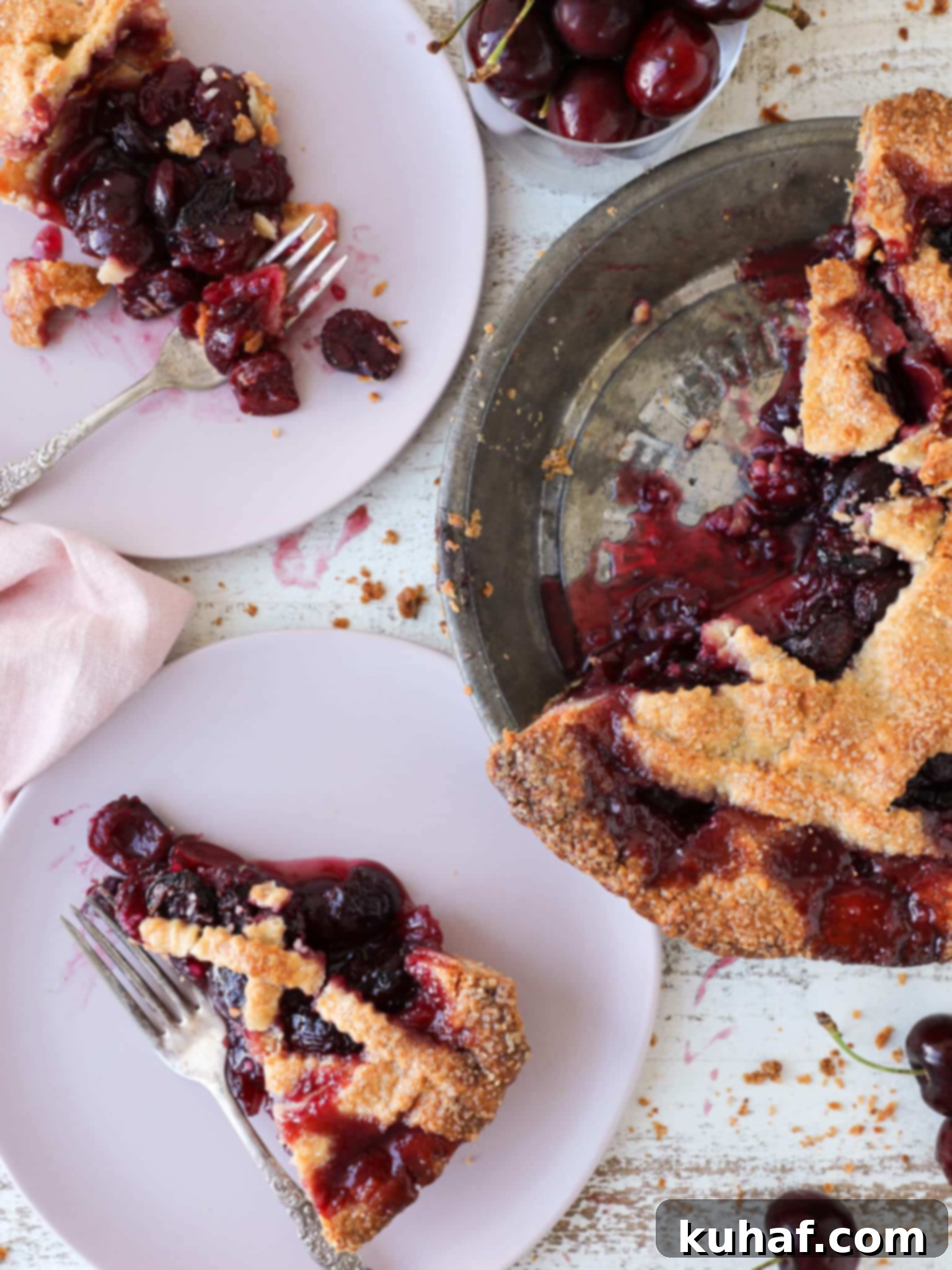 Cherry Pie sliced in a vintage pie tin, showcasing a perfectly golden crust and vibrant red filling.