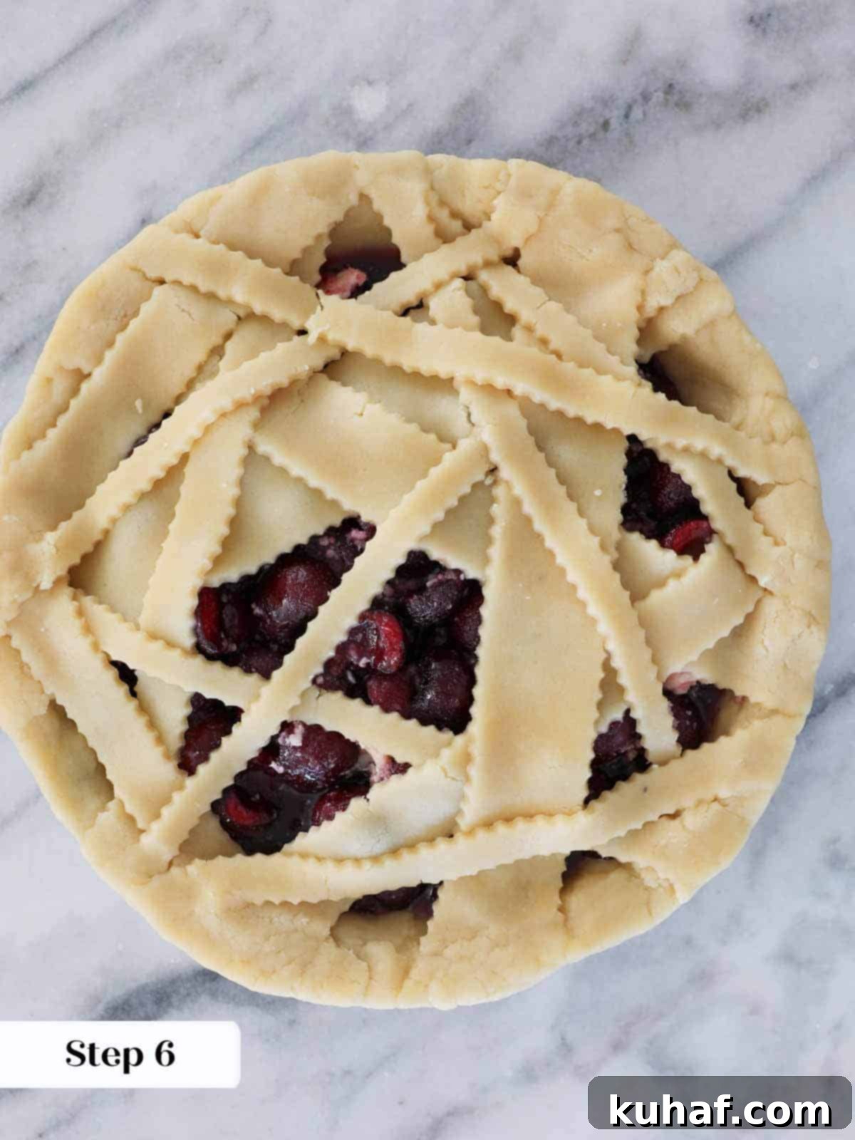 An unbaked cherry pie with a trimmed crust, ready for the oven.