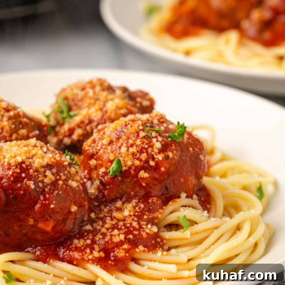 Fluffy Ricotta Meatballs 11 plated meatballs with spaghetti.