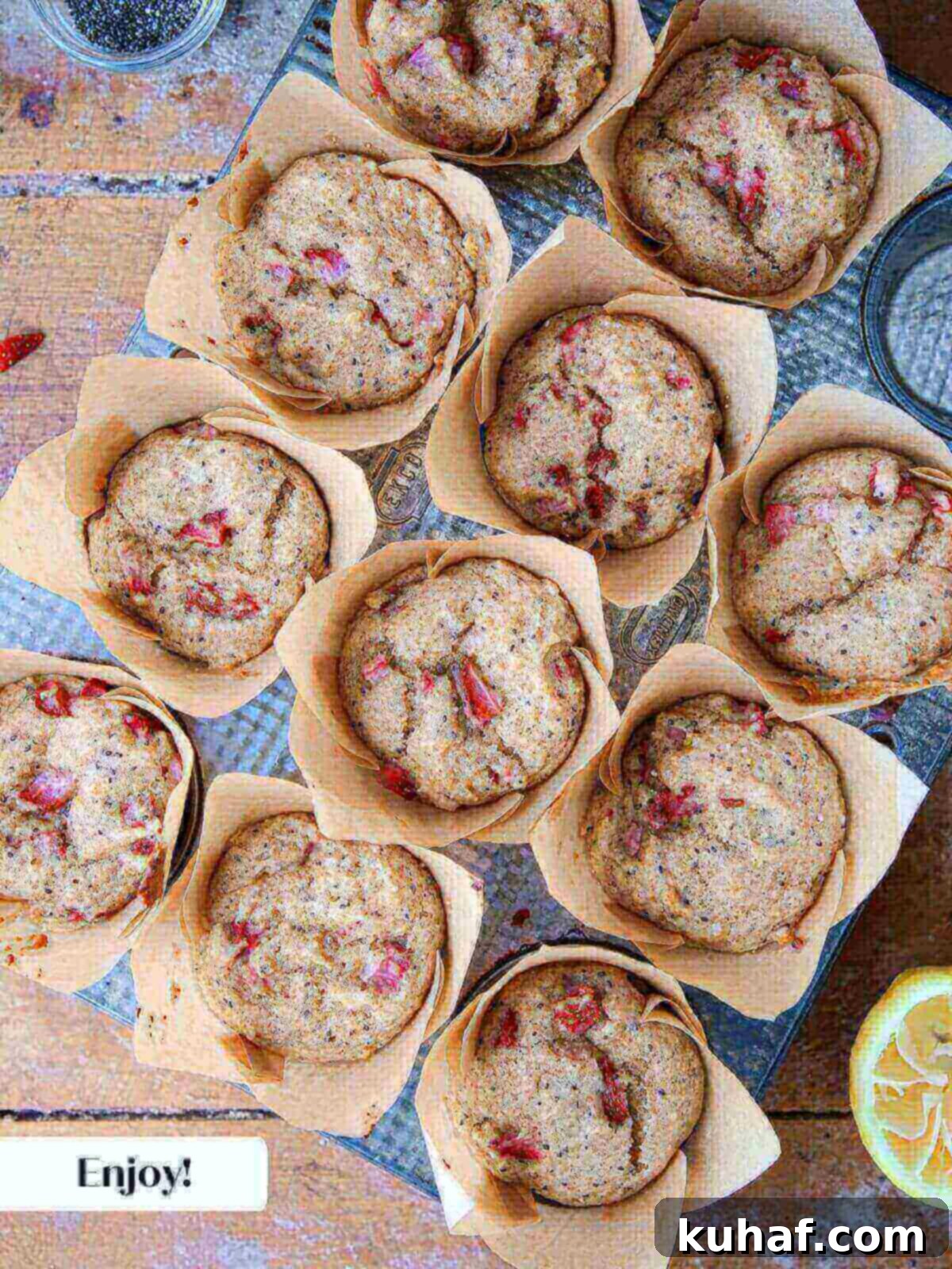 Delicious Strawberry Muffins 11 A tray of freshly baked strawberry muffins, golden brown and perfectly domed, cooling on a wire rack after being removed from the oven.