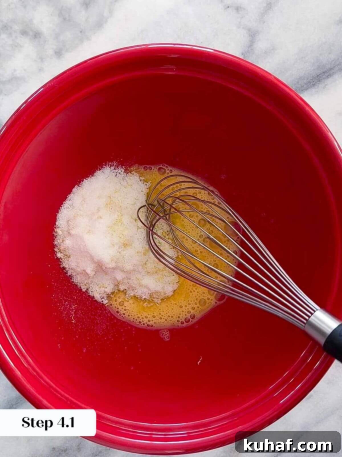 Delicious Strawberry Muffins 5 Adding granulated sugar to a bowl containing lemon zest and freshly squeezed lemon juice, preparing the wet ingredients for the muffin batter.