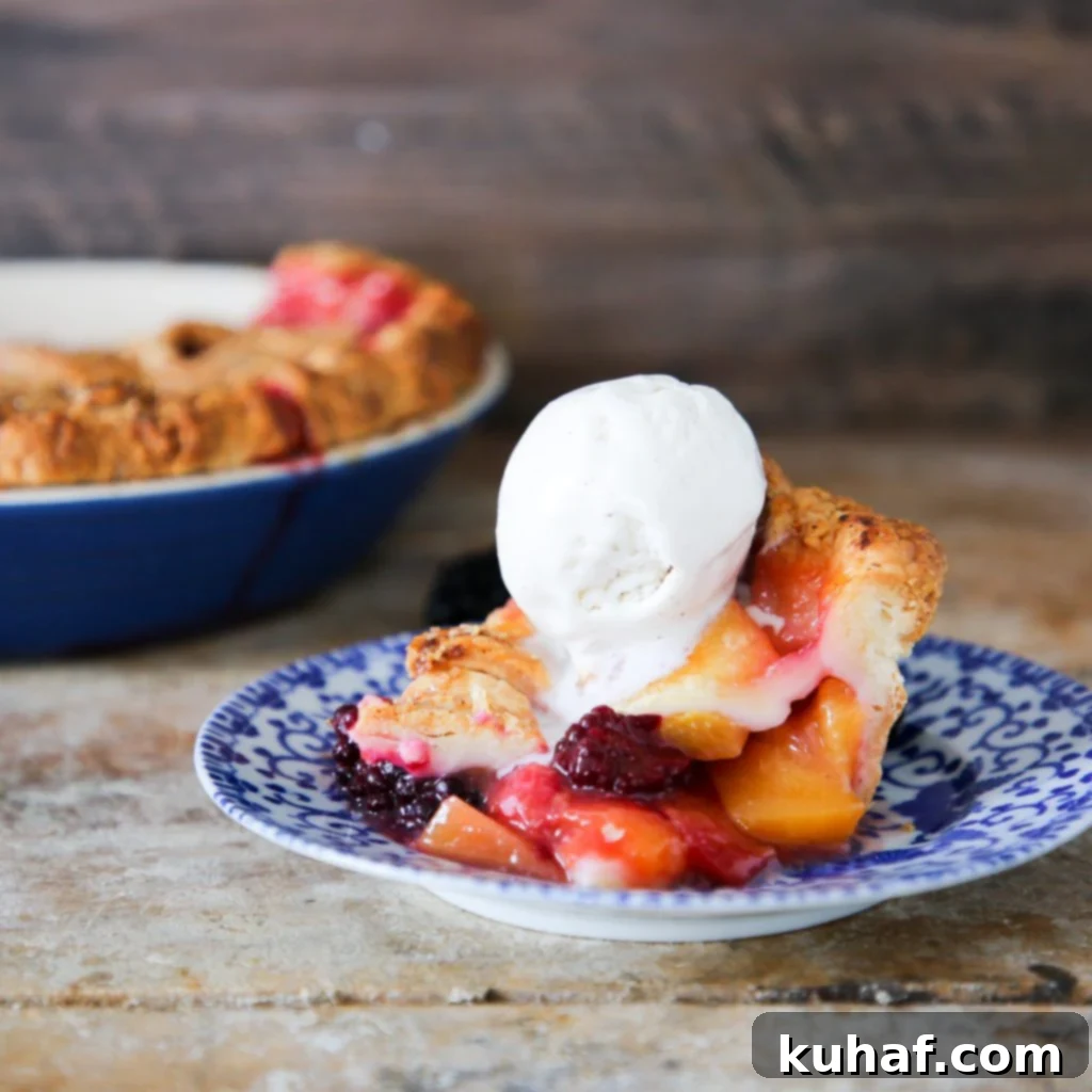 A whole Peach Blackberry Pie on a cooling rack