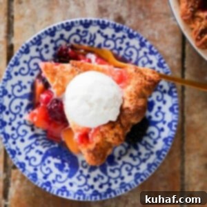 Peach Blackberry Pie on blue plate with ice cream