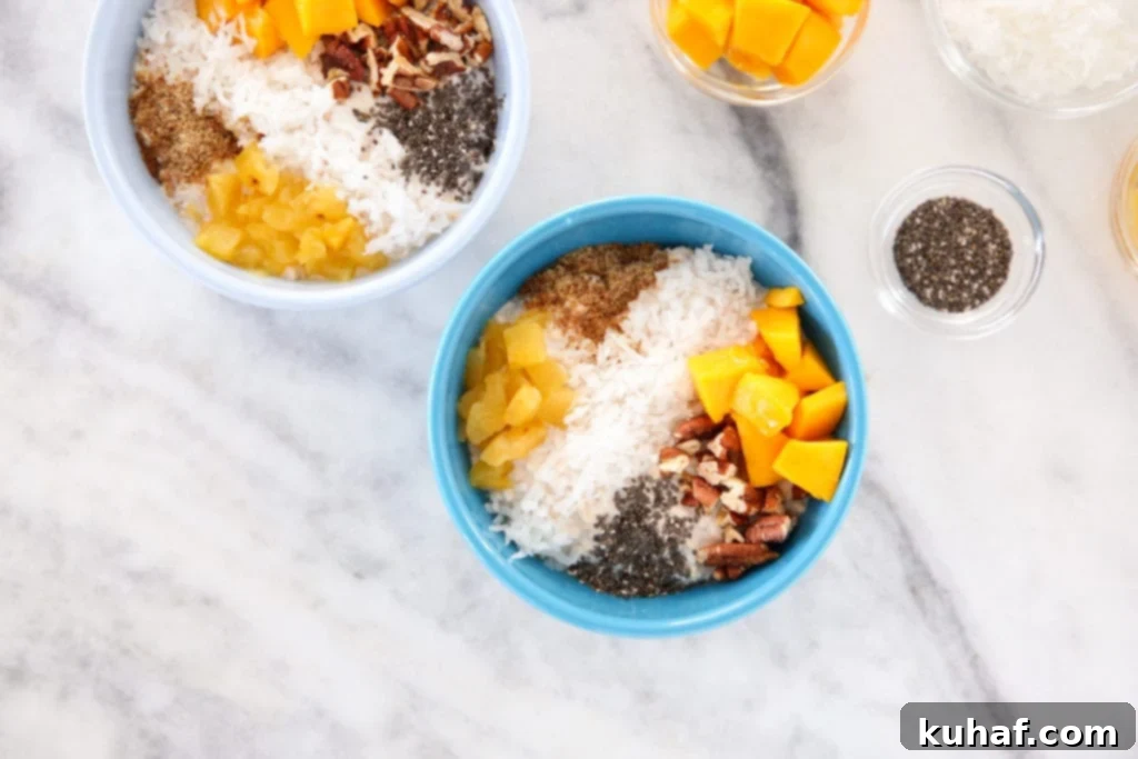 Close-up of creamy tropical overnight oats with fresh fruit toppings.