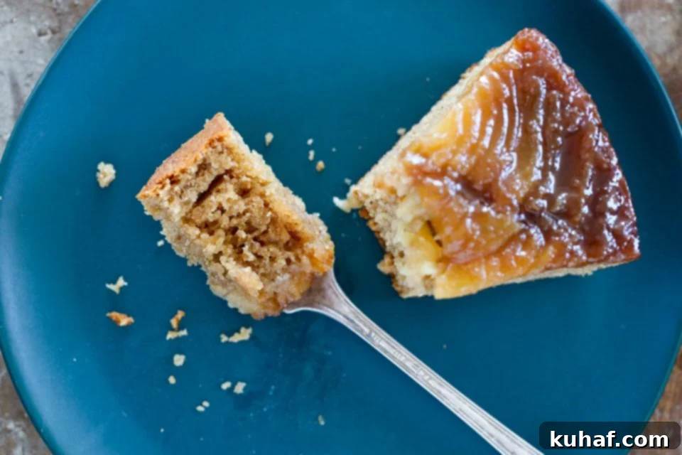 A beautiful slice of Pear Upside Down Cake on a blue plate.