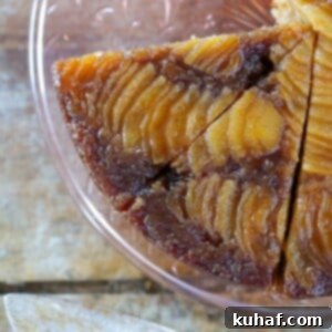 Pear Upside Down Cake sliced on a pink cake plate