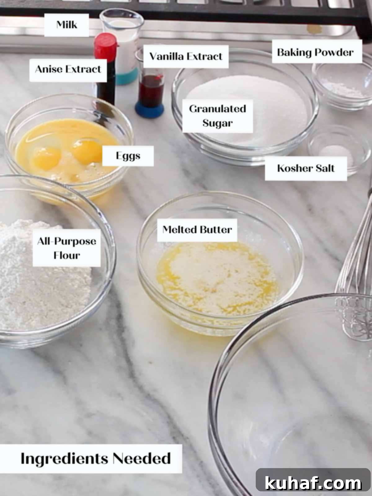 Pizzelle ingredients laid out on a marble surface with labels.
