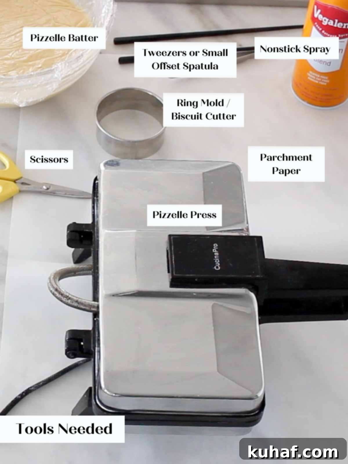 Pizzelle making equipment, including a pizzelle press, on a marble surface with labels.