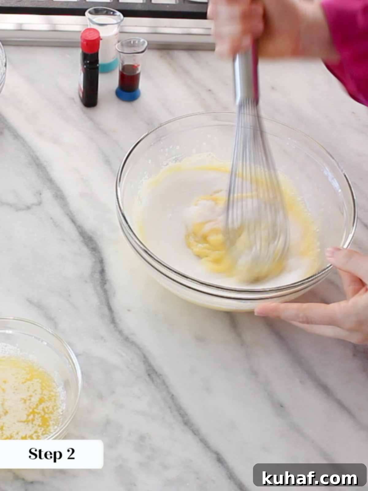 Whisking pizzelle batter in a bowl.
