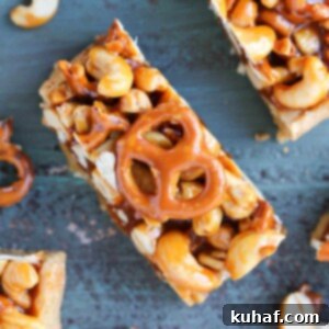 Delicious Cashew Caramel Pretzel Blondies on a teal wooden surface, ready to be enjoyed.