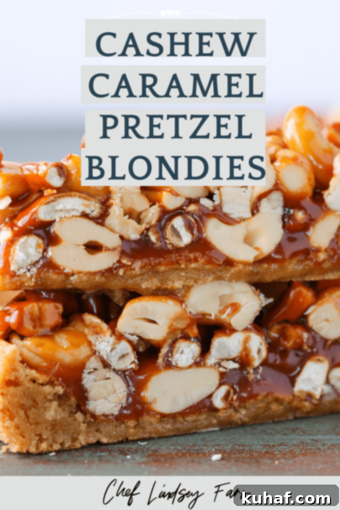 Stacked Cashew Caramel Pretzel Blondies with visible layers of blondie, caramel, nuts, and pretzels.