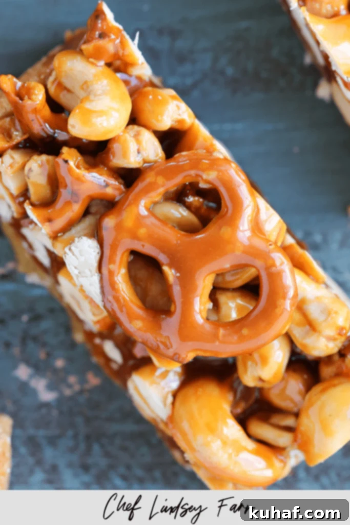A single Cashew Caramel Pretzel Blondie bar, perfectly cut and ready to eat.