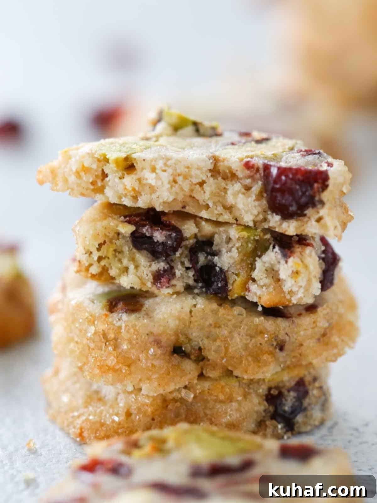 Close-up interior texture of cranberry orange shortbread, showing visible pistachios and cranberries baked into the tender crumb.