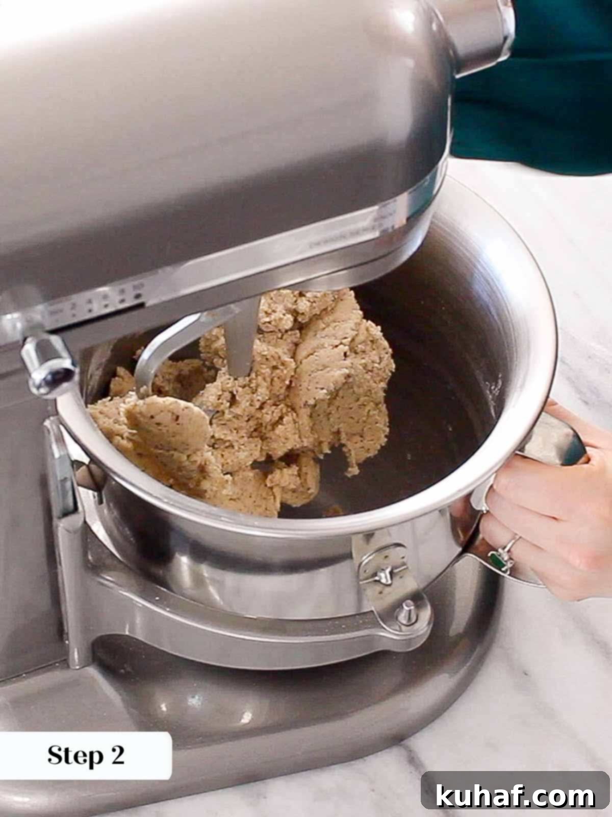 Fully mixed cookie dough in a stand mixer bowl, ready for chilling.
