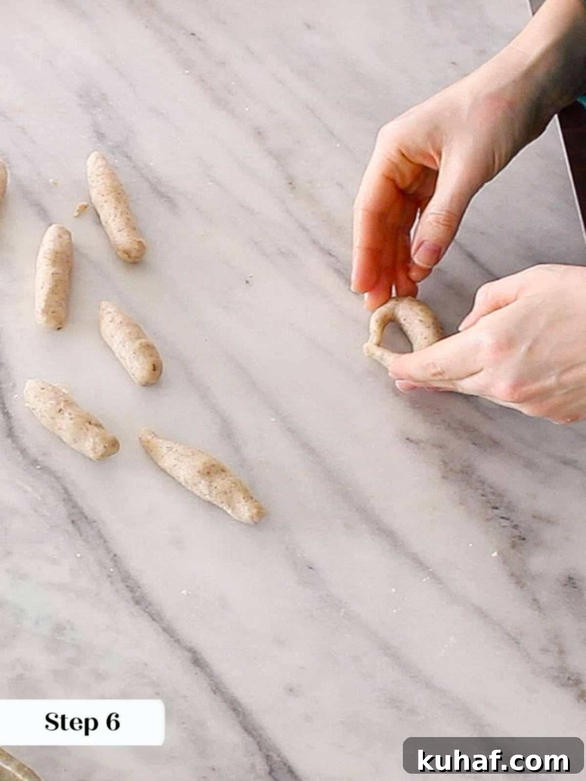 Shaping dough ropes into perfect crescent moons.