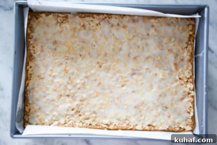 Crunchy almond cookies uncut in a silver baking pan, freshly baked.