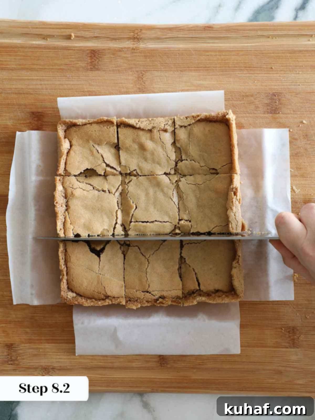 cutting butterscotch brownies on cutting board.