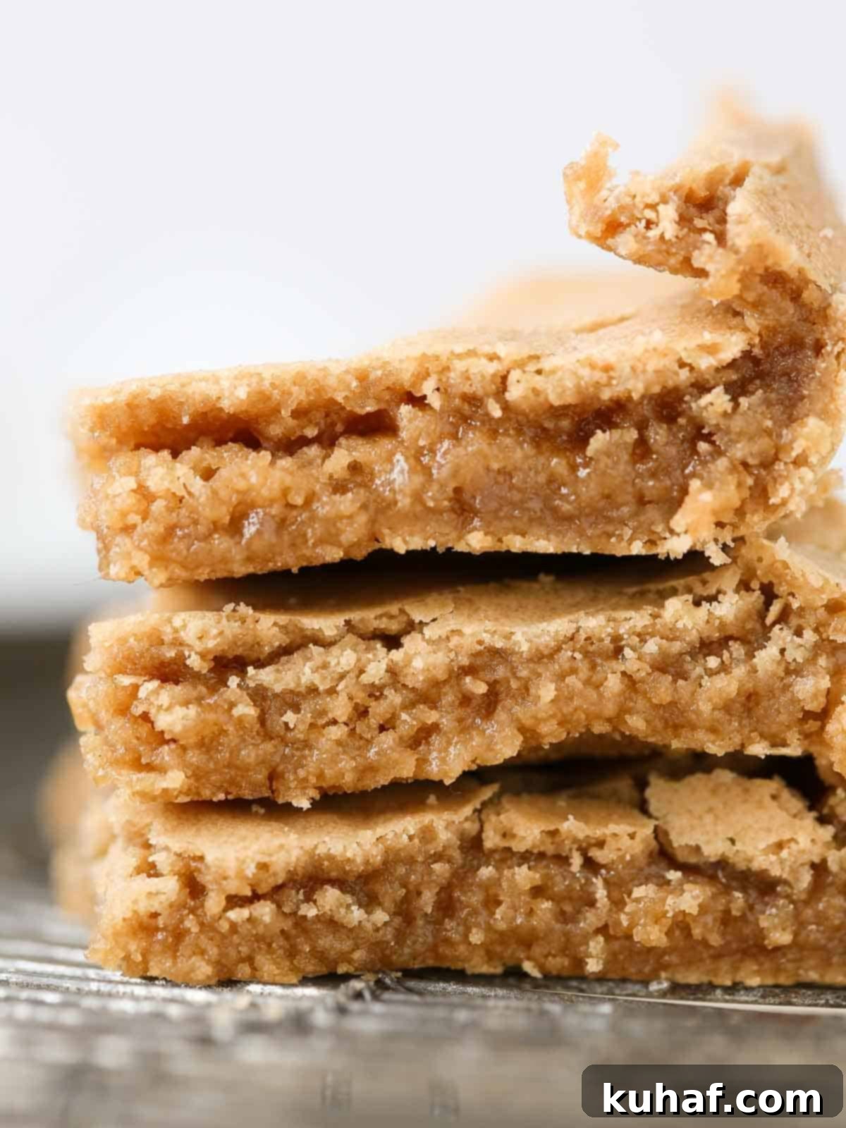 3 butterscotch brownies stacked on wire rack.