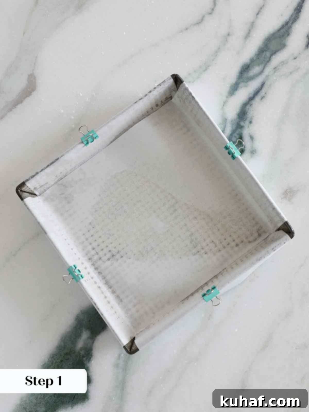 8x8 inch pan prepared with parchment and binder clips.