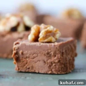 sliced fudge square with walnut on top.