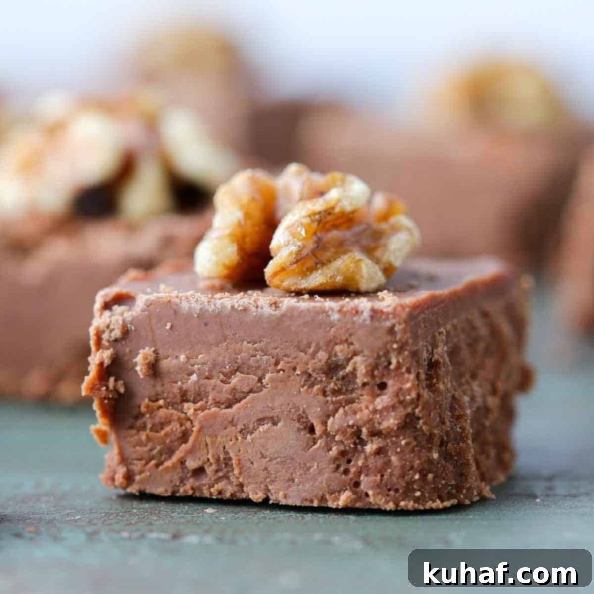 sliced fudge square with walnut on top.