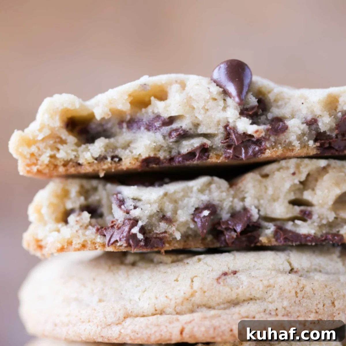 chocolate chip cookie broken open with melty chips.