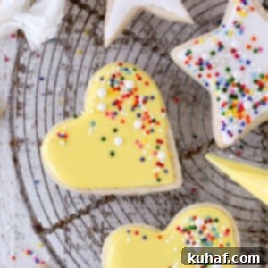 icing yellow heart shaped sugar cookies.