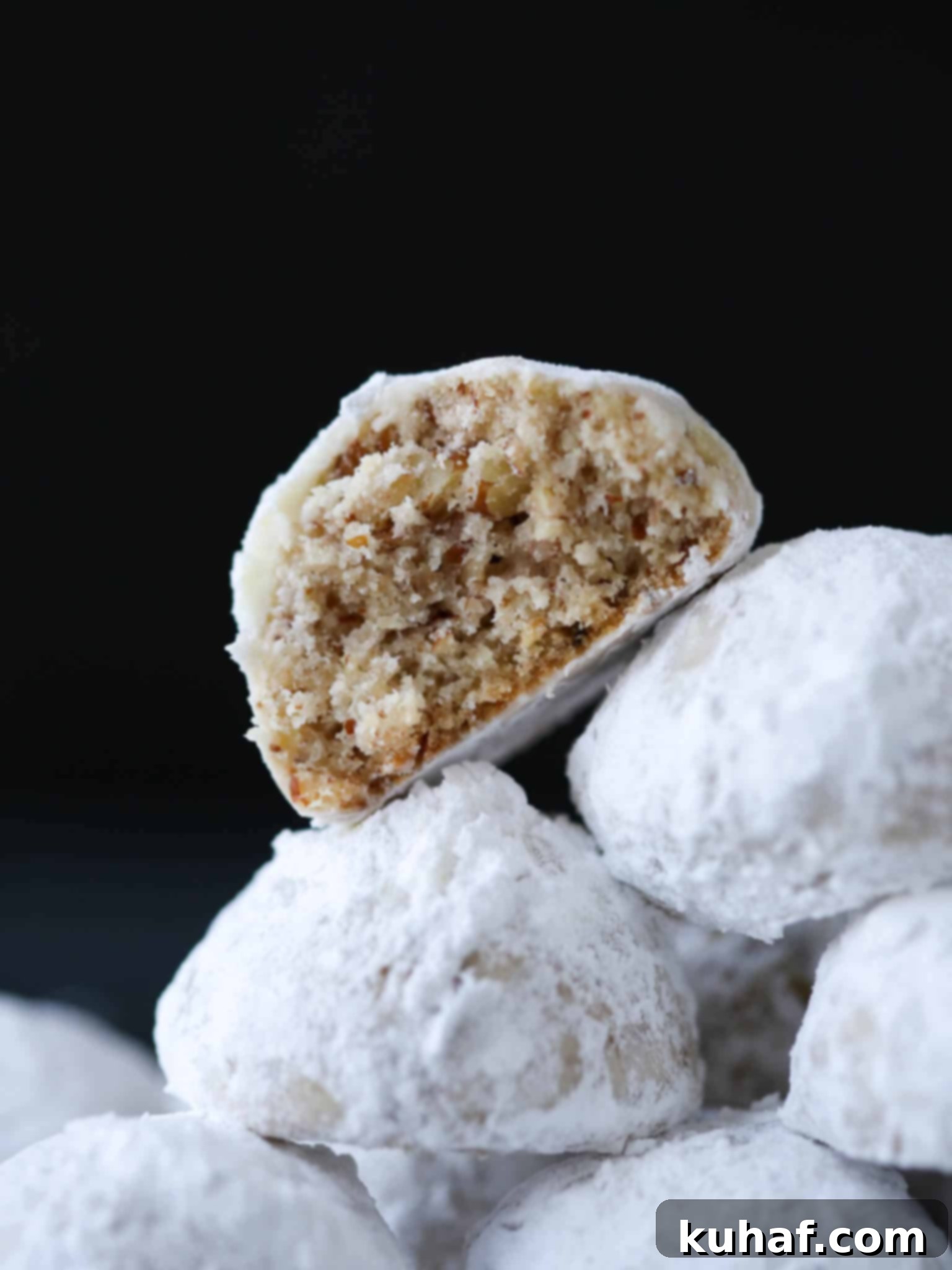 Pecan Snowball Cookies stacked cut open.