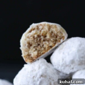 Easy Christmas cookies, pecan snowball cookies against a black backgorund.