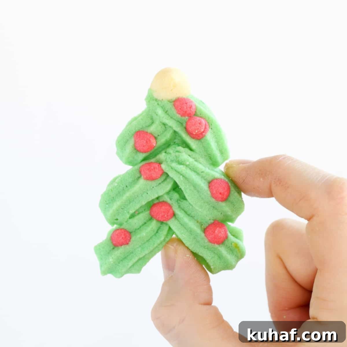 Holiday Spritz cookie Christmas tree in hand.