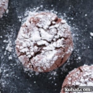 Chocolate Crackle Cookie with powdered sugar on black surface Easy Chocolate Desserts.