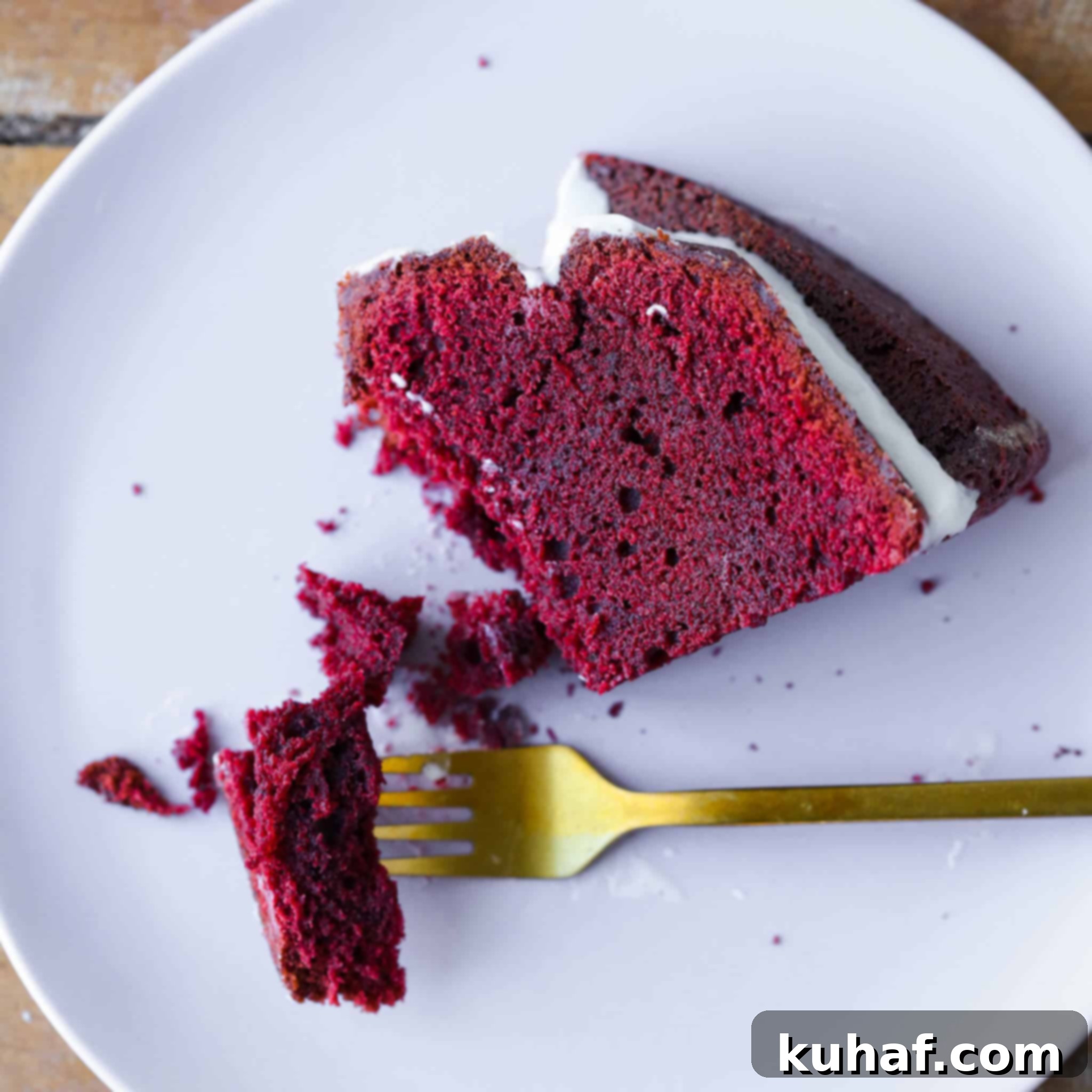 Red Velvet Pound Cake 4 Individual slice of Red Velvet Pound Cake with Cream Cheese Glaze on a white plate, showcasing the vibrant red color.