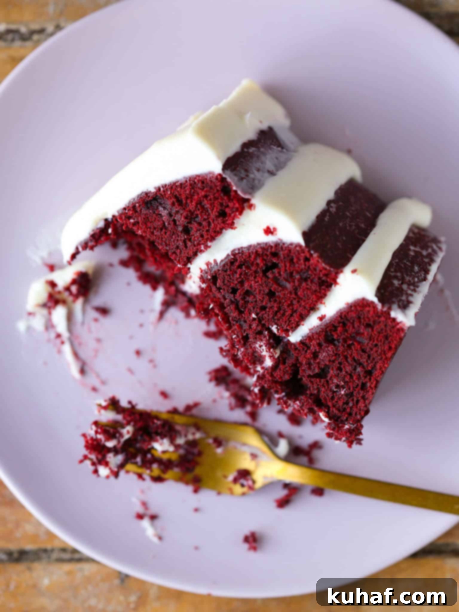 Flawless Red Velvet Cake Every Time 2 Red Velvet Layer Cake with Cream Cheese Buttercream, a slice on a plate, partially eaten, perfect for Valentine's Day Desserts.