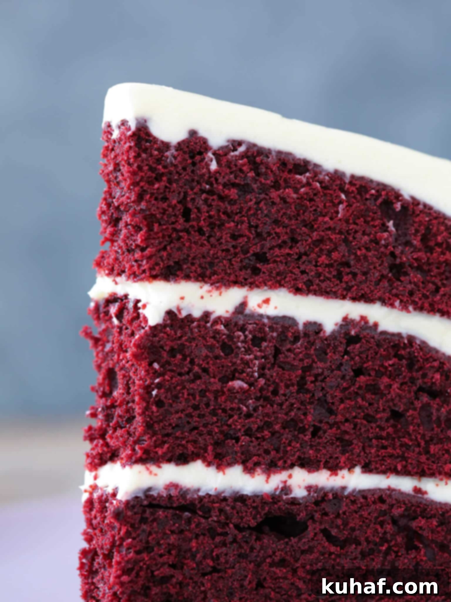 Flawless Red Velvet Cake Every Time 4 Red Velvet Layer Cake Cream Cheese Buttercream slice detail, highlighting the moist crumb and creamy frosting.