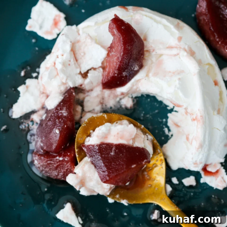 A Poached Pear Pavlova presented on a rustic wooden board, ready for serving.
